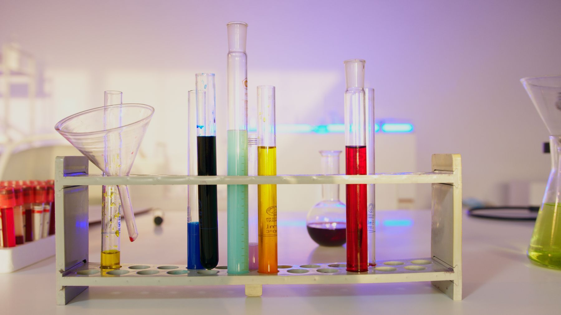 Laboratory vials with coloured liquids in a rack